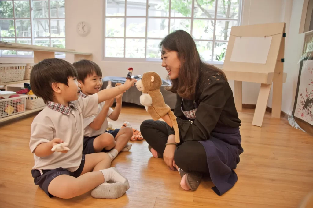 Preschool teacher using a puppet to engage children's curiosity