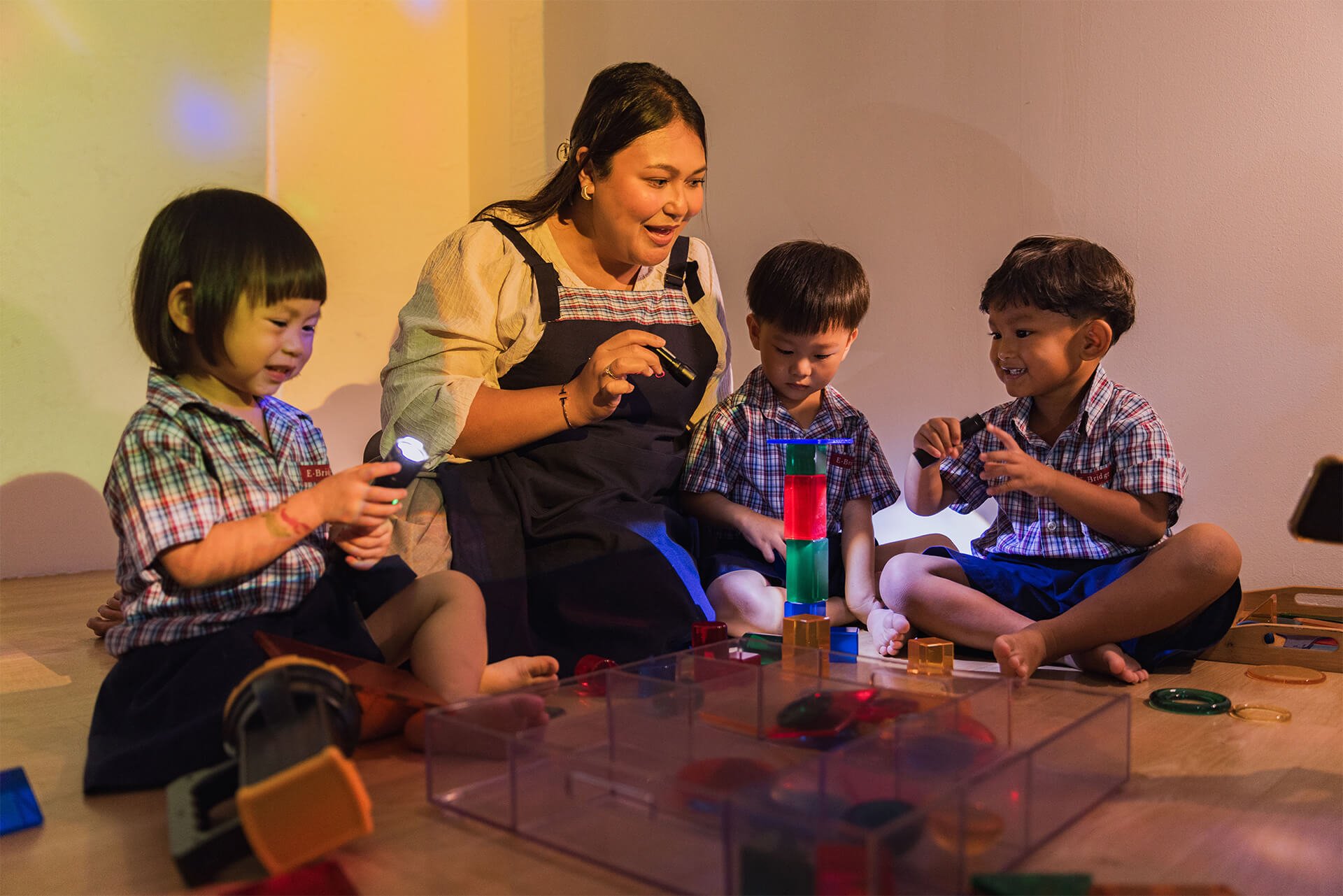 Teacher and students at E-Bridge learning with flashlights