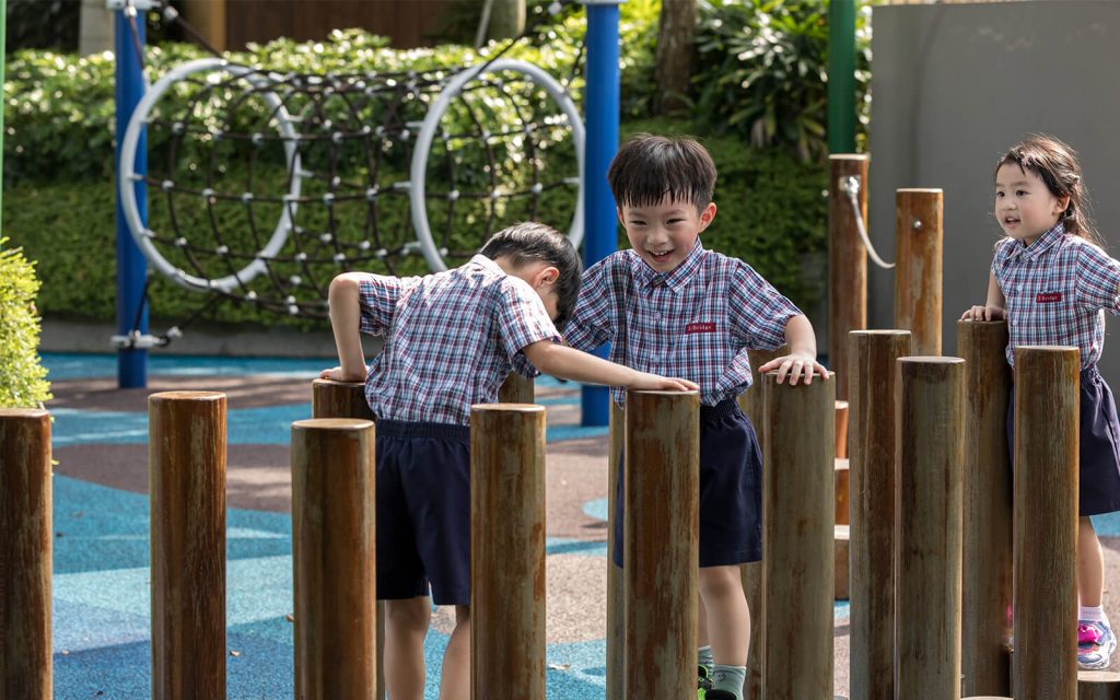 Children playing on an e-bridge preschool playground obstacle course