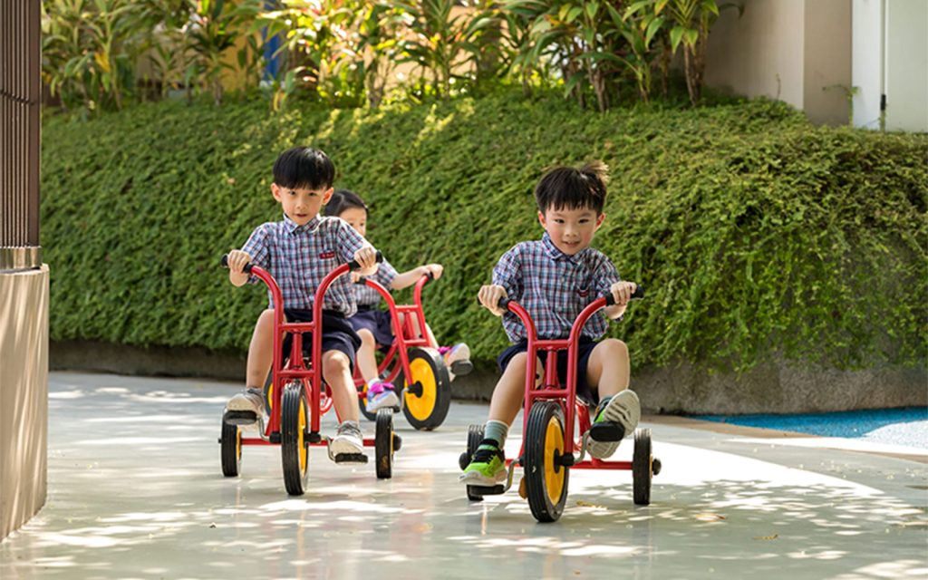 Children playing outdoors, developing gross motor skills