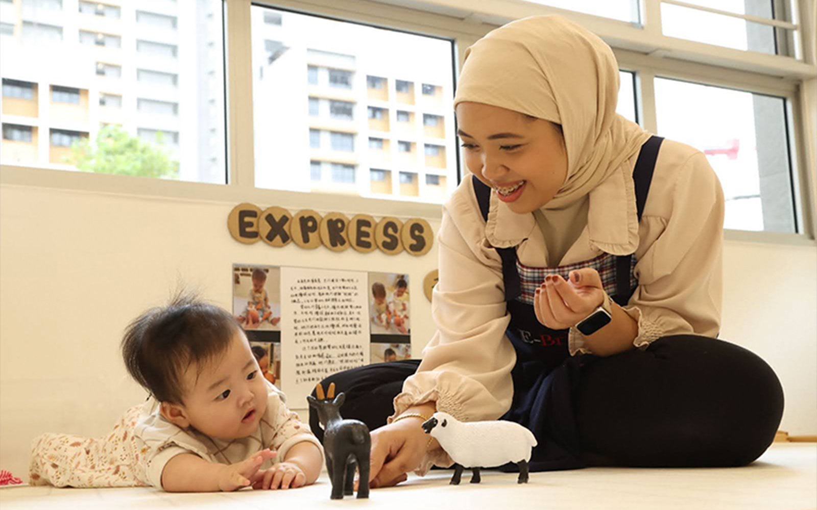 E-Bridge teacher nurturing baby's emotional development