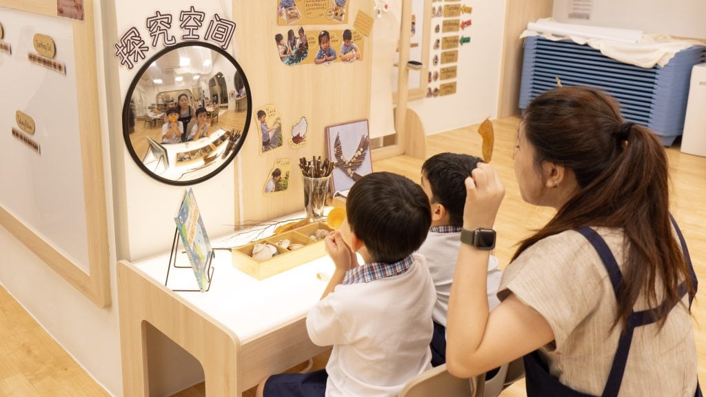Teacher and young students engaging in preschool classroom activities