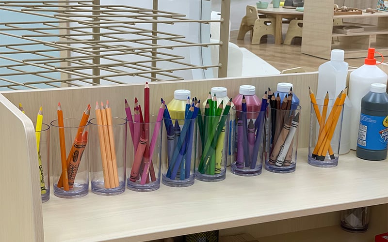 Color-sorted art supplies for open-ended creative play in preschool.